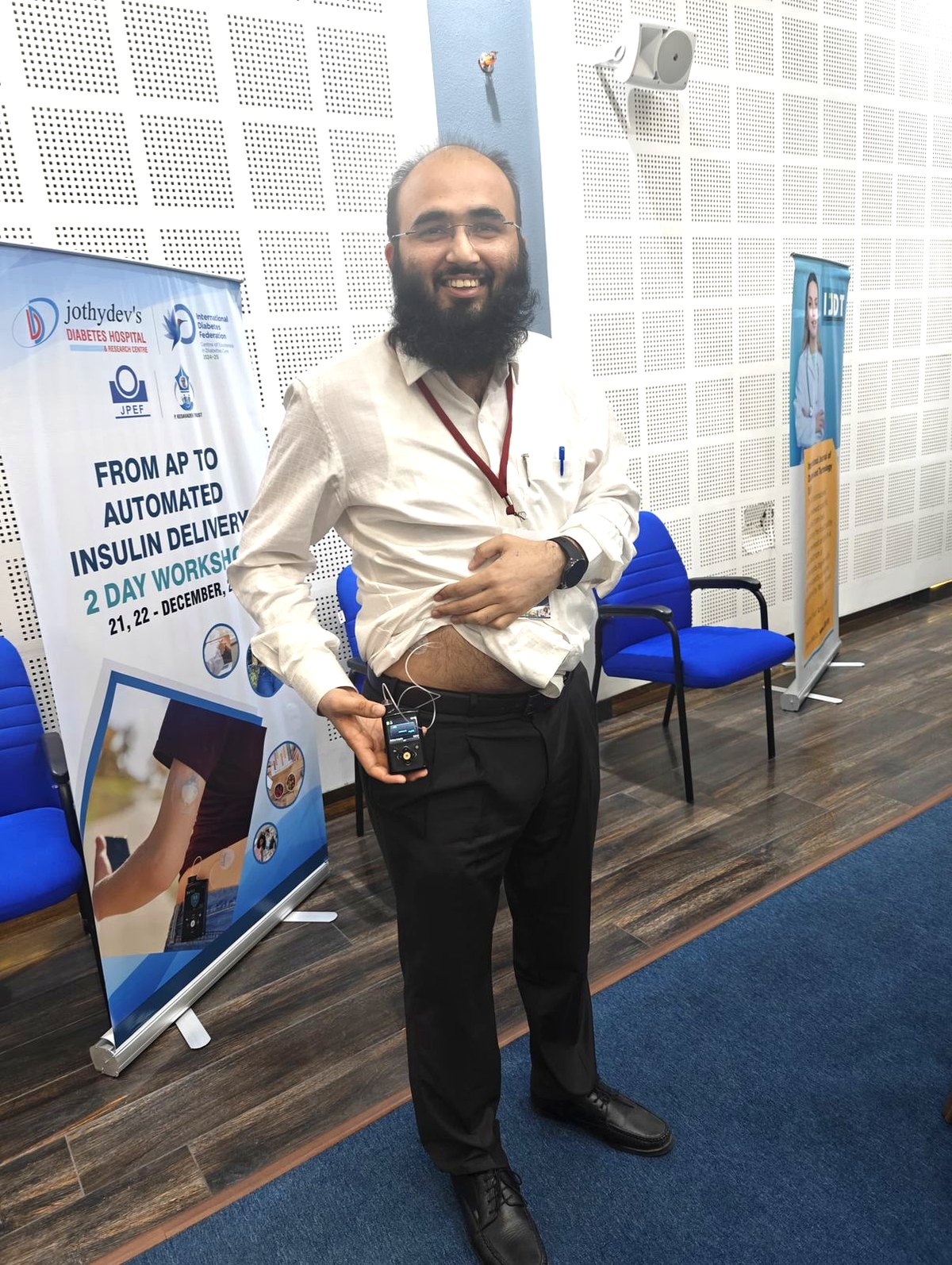 Dr. Khizer Hussain Junaidy wearing a MiniMed insulin pump himself, with the infusion set attached, at the &lsquo;From AP to Automated Insulin Delivery&rsquo; two-day workshop.